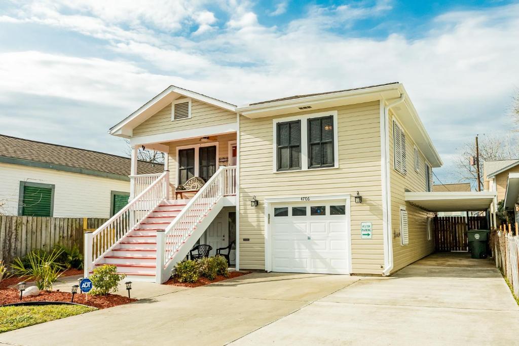a white house with a white garage at Nautical Niche-Master in Galveston