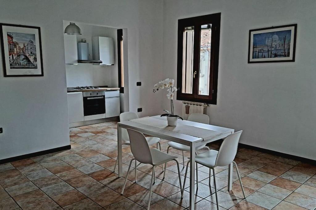 a kitchen and dining room with a table and chairs at Ca' Piave in Mestre