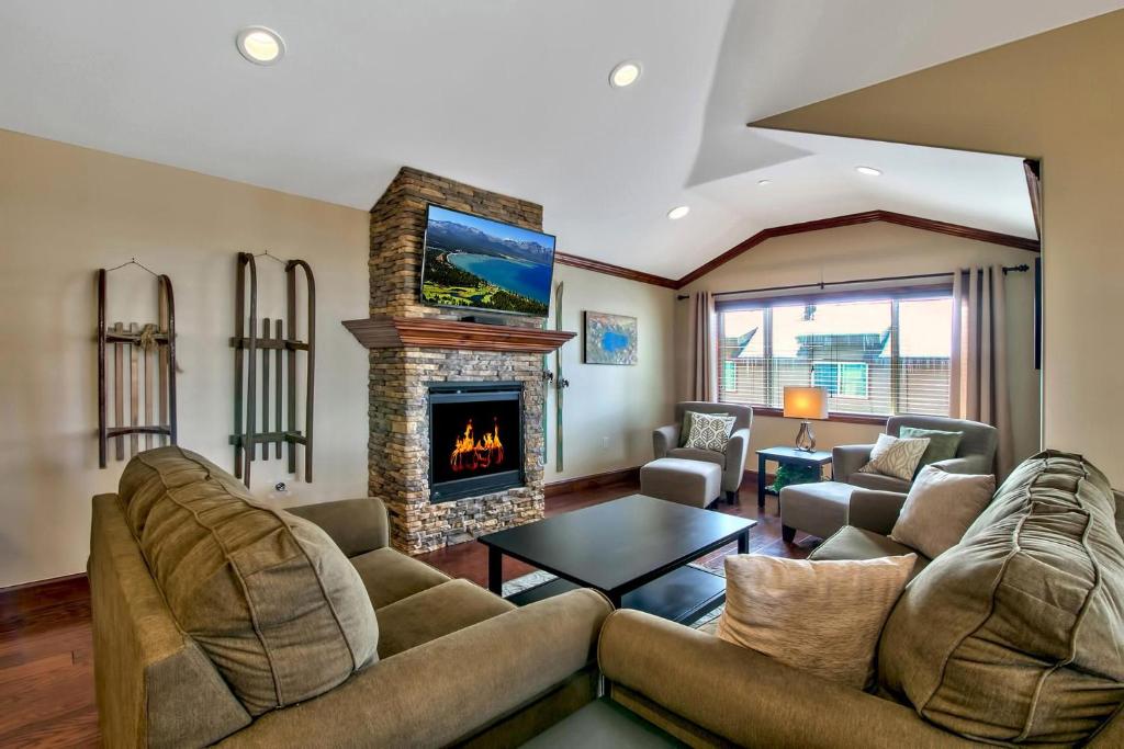 a living room with a couch and a fireplace at Conifer Chalet in South Lake Tahoe