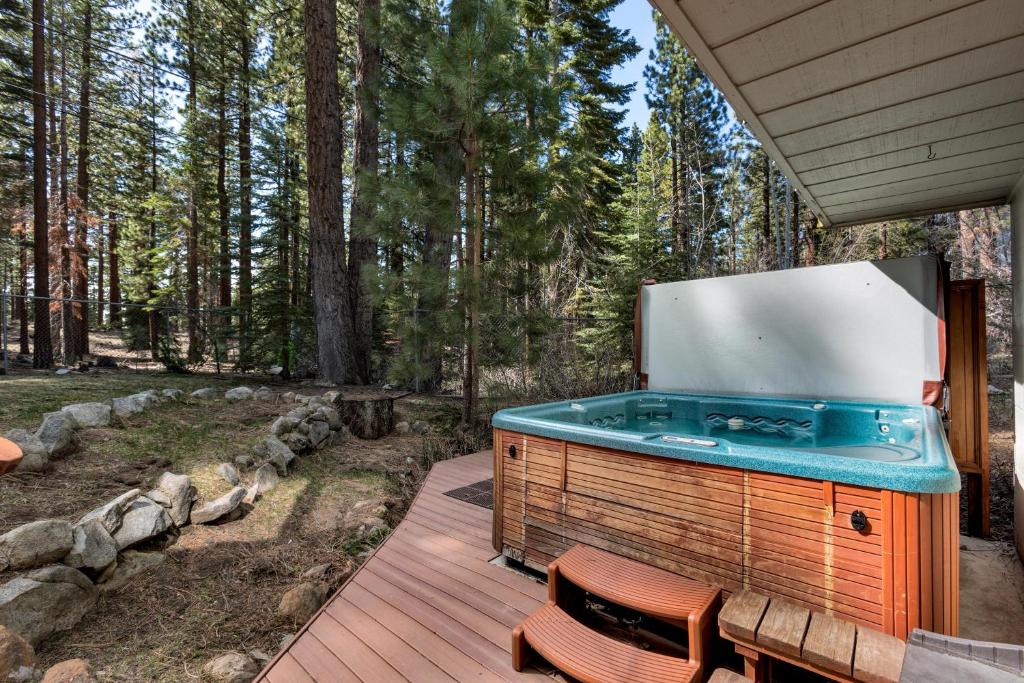 a hot tub on a deck in the woods at Sundown Lodge in Stateline