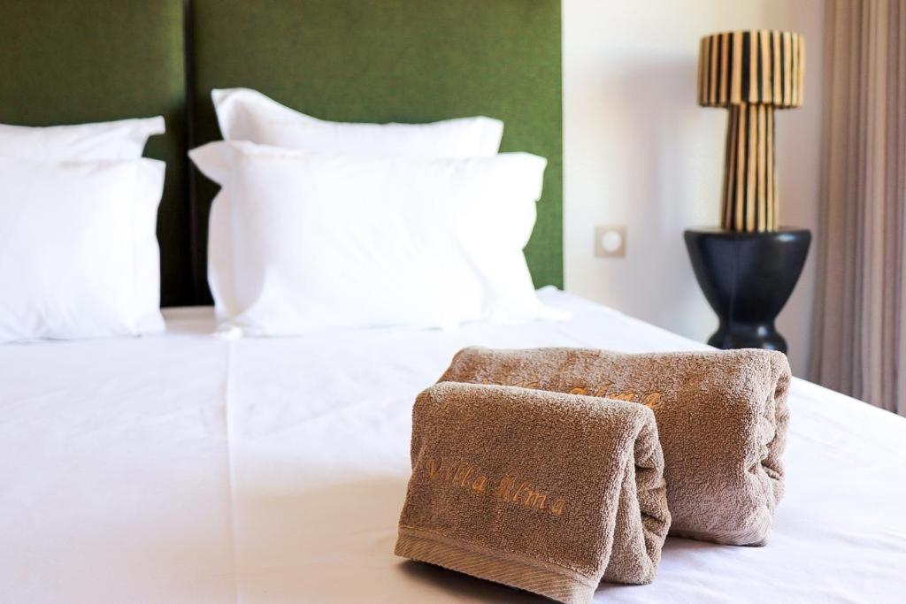 a bedroom with a bed with a towel on it at Villa Alma, luxueuse villa au cœur de Marrakech in Marrakesh