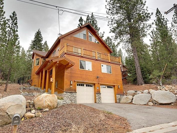 a large wooden house with two garage doors at Lodgepole Pine Chalet in South Lake Tahoe