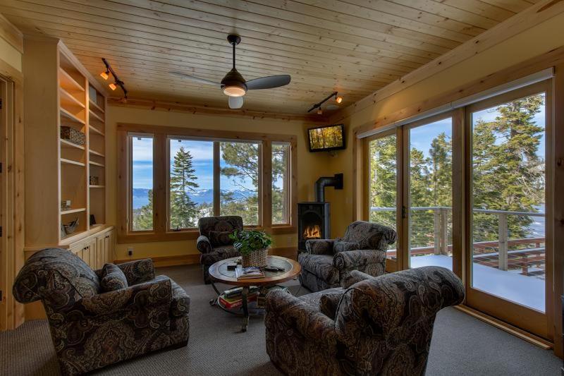 a living room with couches and a table and windows at Rock Haven in Stateline