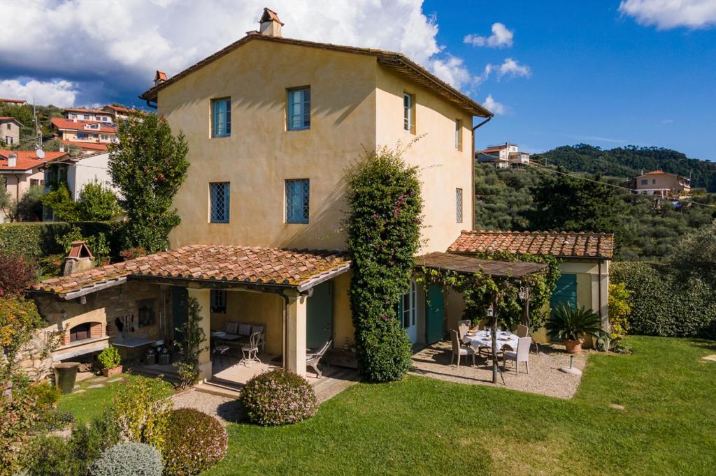 an image of a large house with a yard at Casa Tabarro in Camaiore