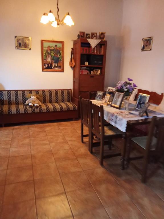 a living room with a table and a couch at house FYNTIKAKH - SKALA in Anopoli Sfakion