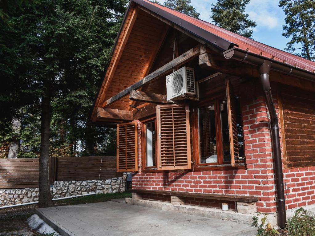 a small brick house with a window with an air conditioner at Vikendica MINI in Jotanovići