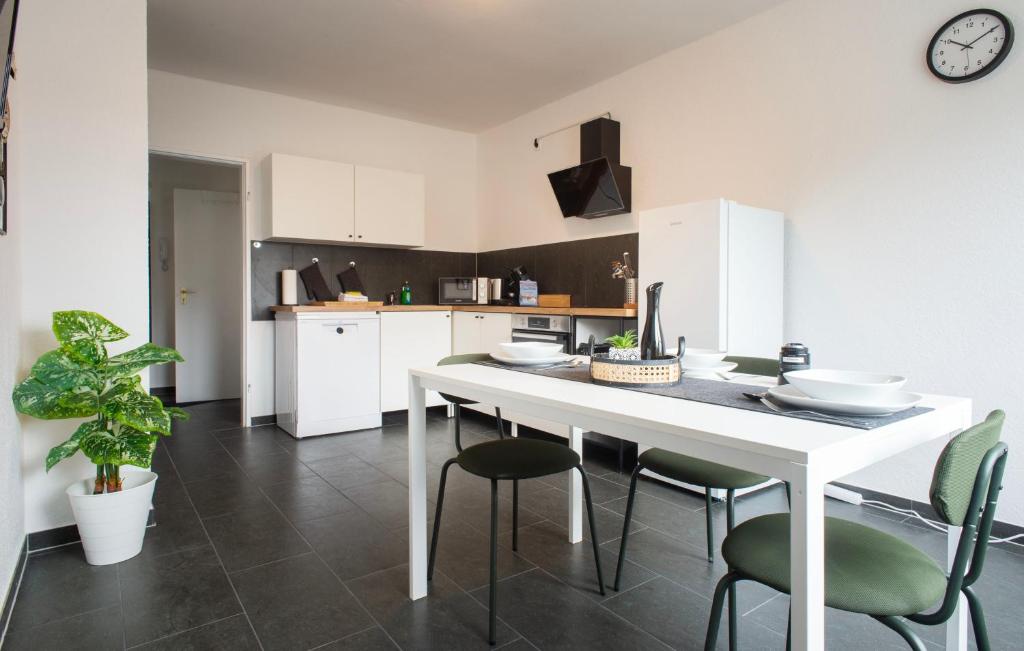 una cocina con una gran mesa blanca y sillas en Modern cozy apartment - three box spring beds, en Gronau