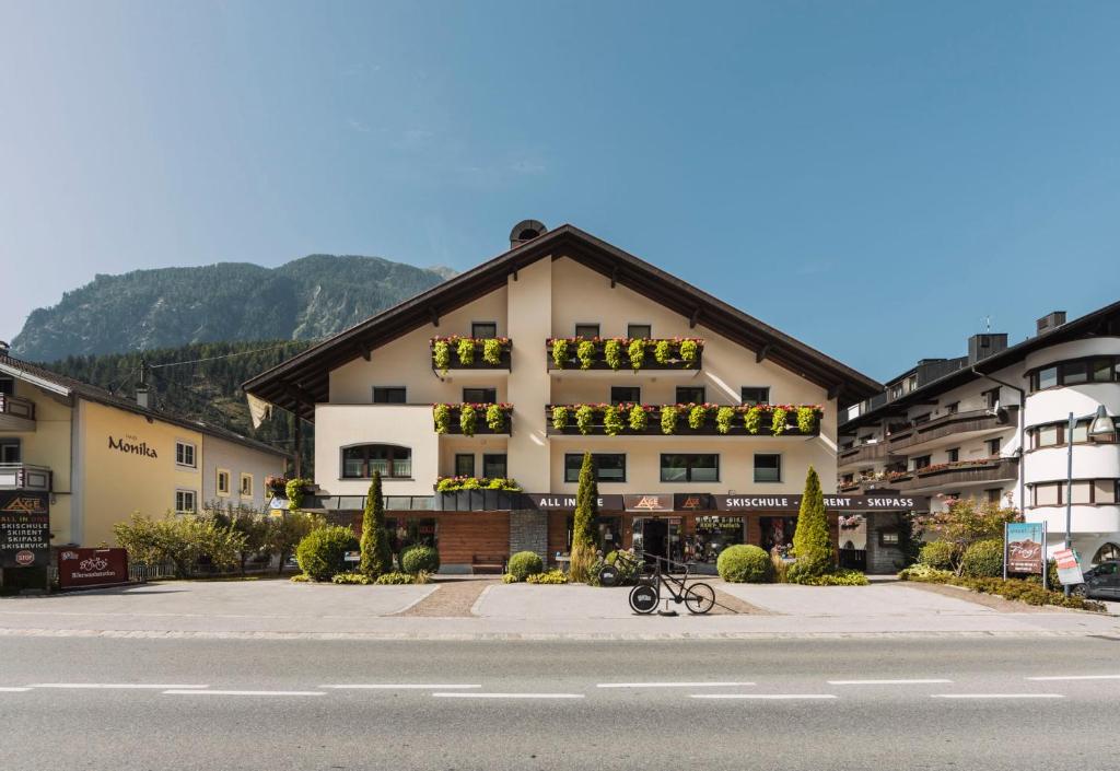 a large building with flowers on the side of it at Appart Mein Fiegl in Oetz