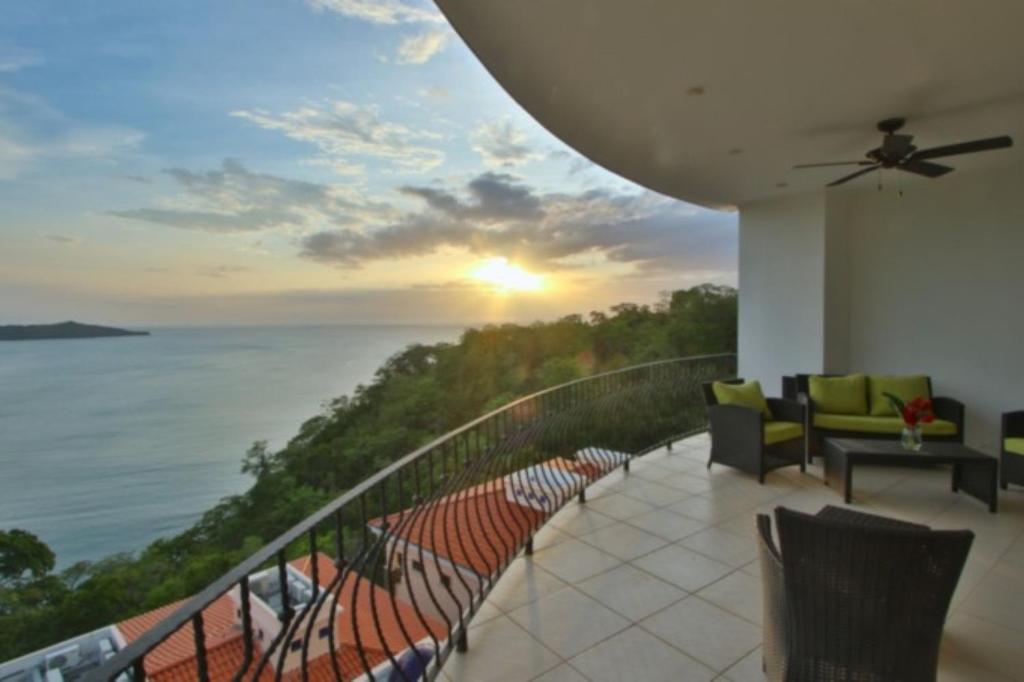 a balcony with chairs and a view of the ocean at Playa Flamingo - 2 BR condo with great ocean views - FLAMINGO TOWERS 25 in Playa Flamingo