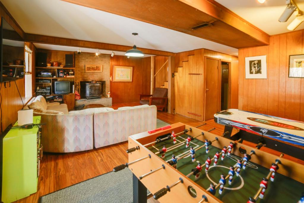 a living room with a pool table and a couch at Londonderry Vacation Home with Deck and Gas Grill! in Londonderry