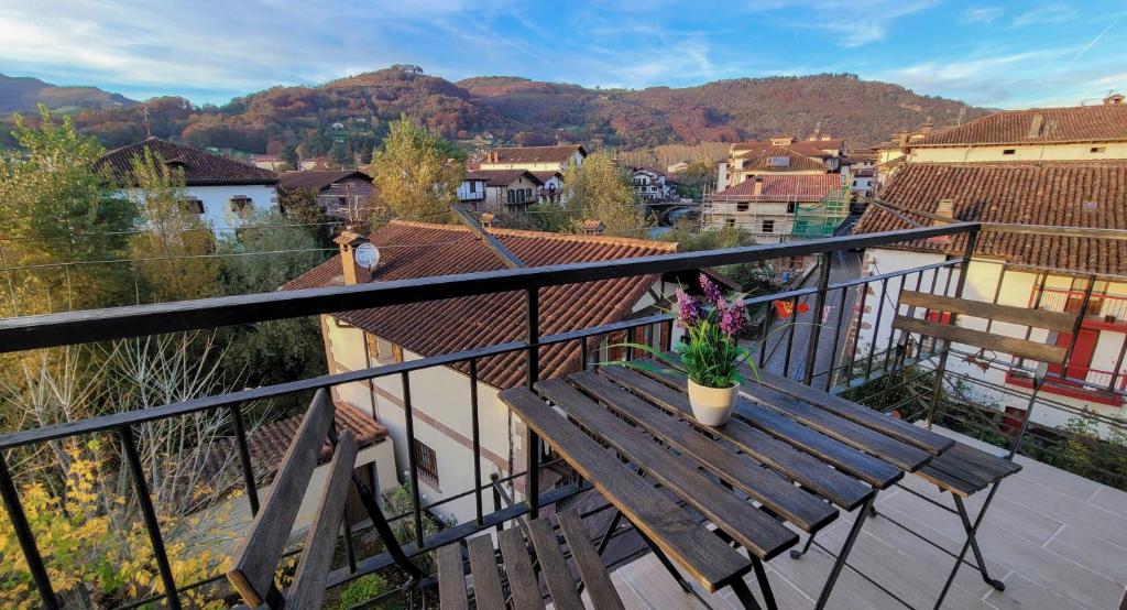 a wooden bench sitting on top of a balcony at Apartamentos Elizondo Center in Elizondo