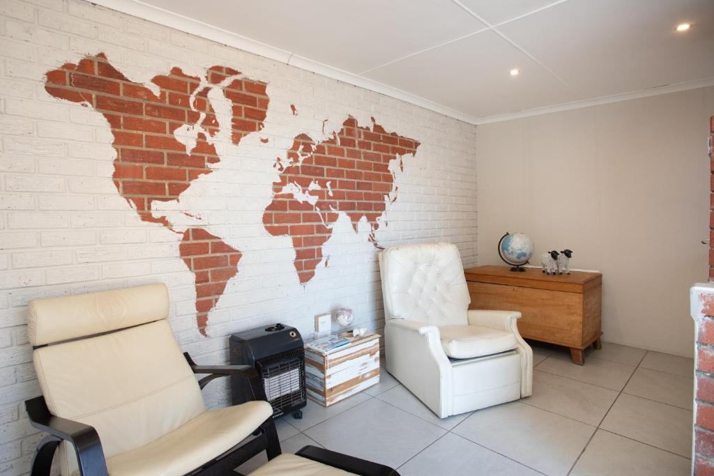 a room with a map of the world on the wall at Shepherd's Rest in Mossel Bay