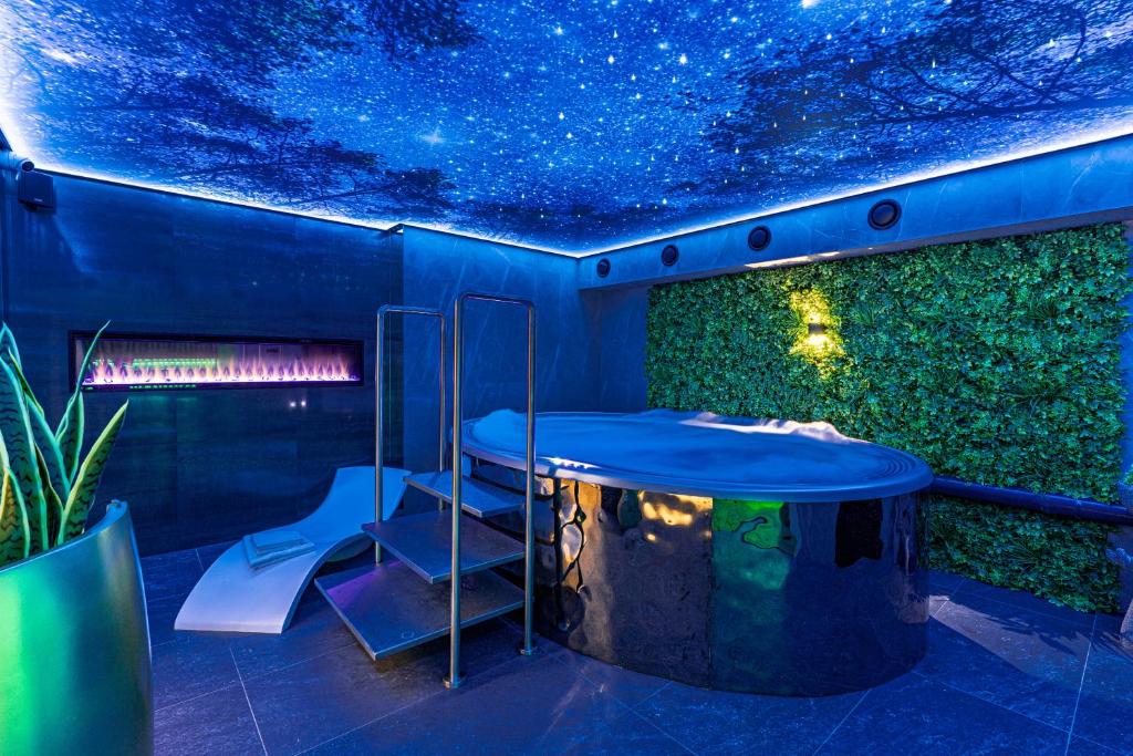 a blue room with a table and a star ceiling at Aparthotel Zakopiański & SPA in Zakopane