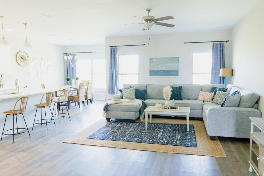 a living room with a couch and a table at Charming Brand New Home in Foley in Foley