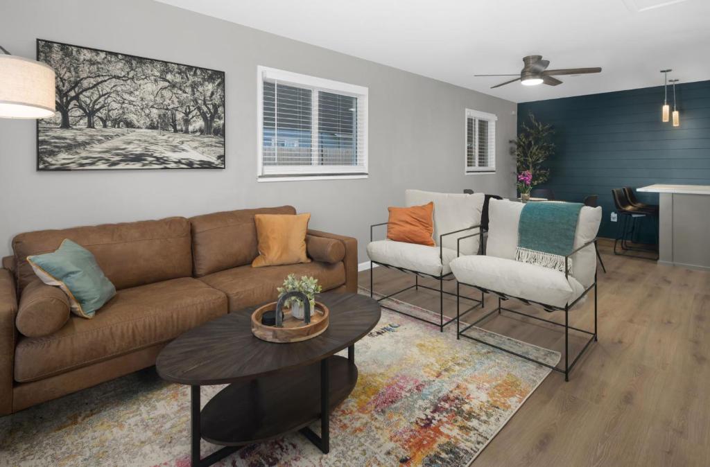 a living room with a couch and two chairs at Spacious home near Anschutz/DIA in Aurora