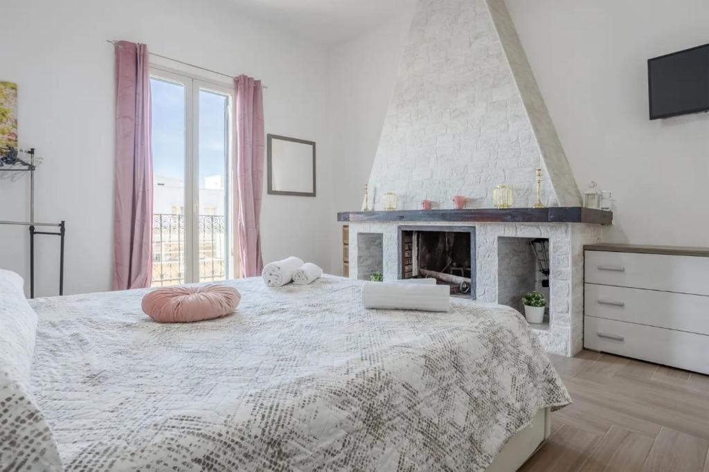 a bedroom with a large bed with a fireplace at L'Incanto centrale in Palermo