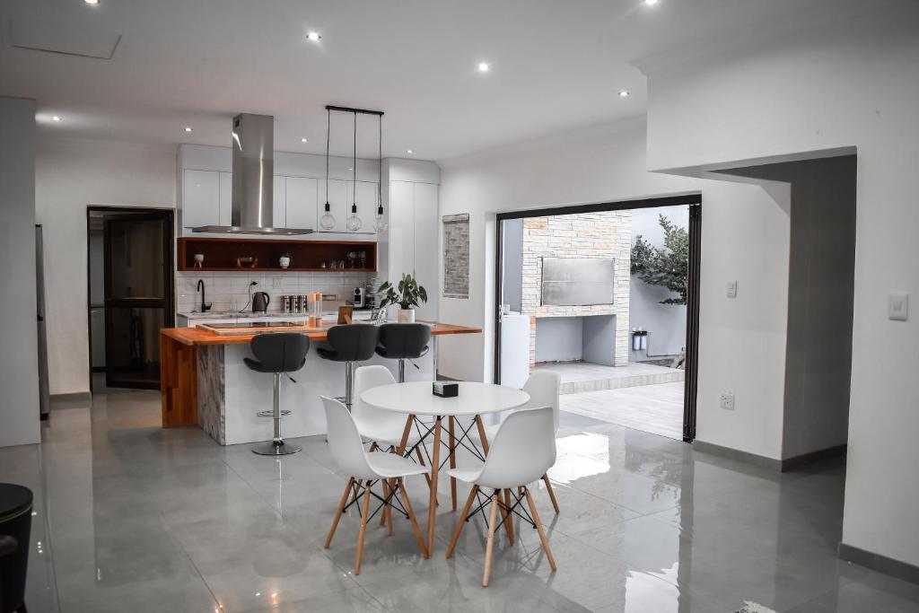 a kitchen with a table and chairs and a counter at Palm Self Catering - House in Walvis Bay in Walvis Bay