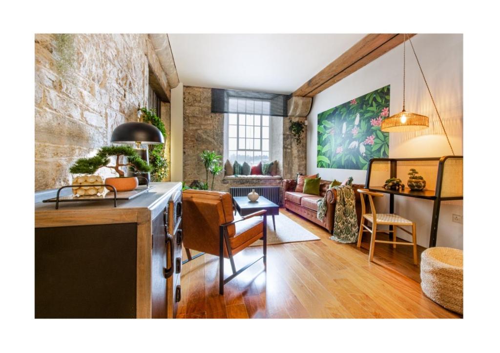 Una cocina y una sala de estar con un sofá y una mesa. en Suite4SerenityRWY Luxury Apartment with Sea view with optional parking, en Plymouth