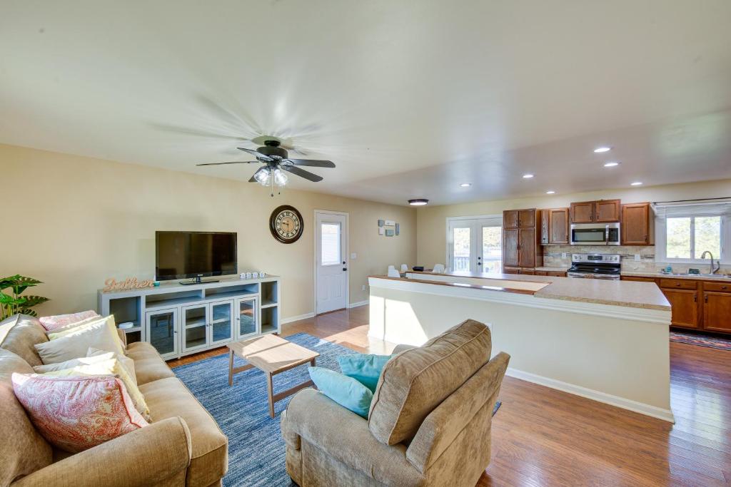 a living room with two couches and a kitchen at Palmyra House with Private Hot Tub and Fenced Yard! in Palmyra