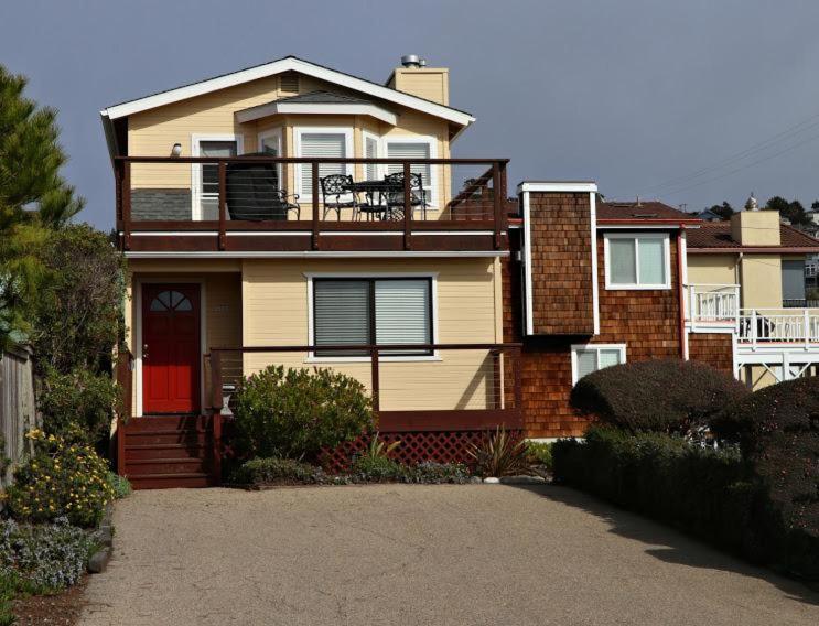 a house with a red door and a balcony at 2116 Windsor Blvd. Marine Terrace in Cambria