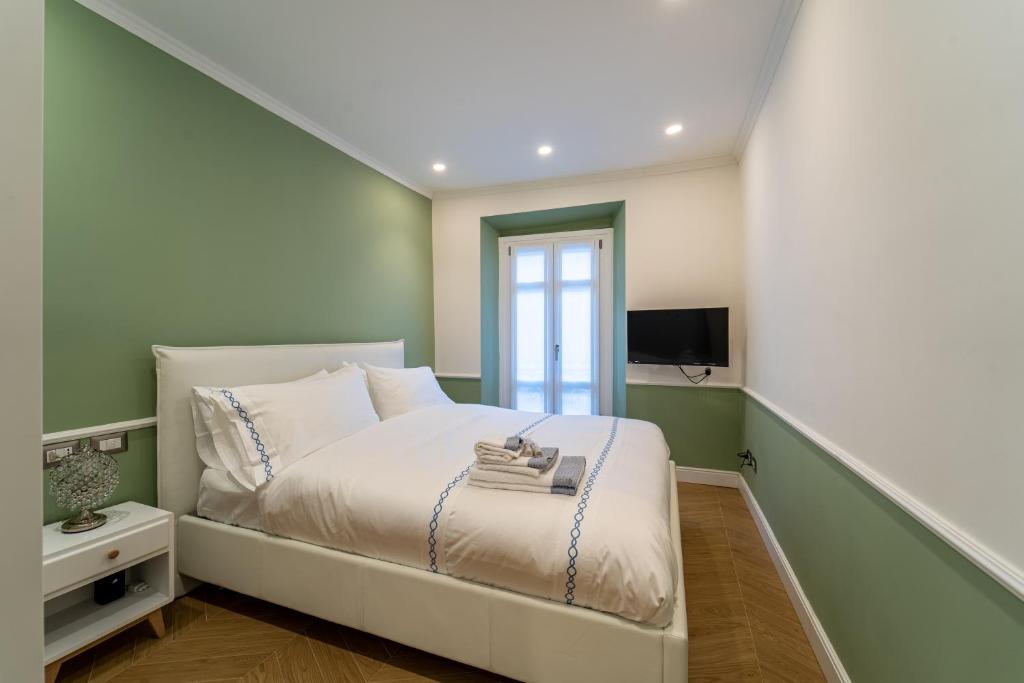 Schlafzimmer mit einem weißen Bett und einem Fenster in der Unterkunft Duomo Guest House in Monza