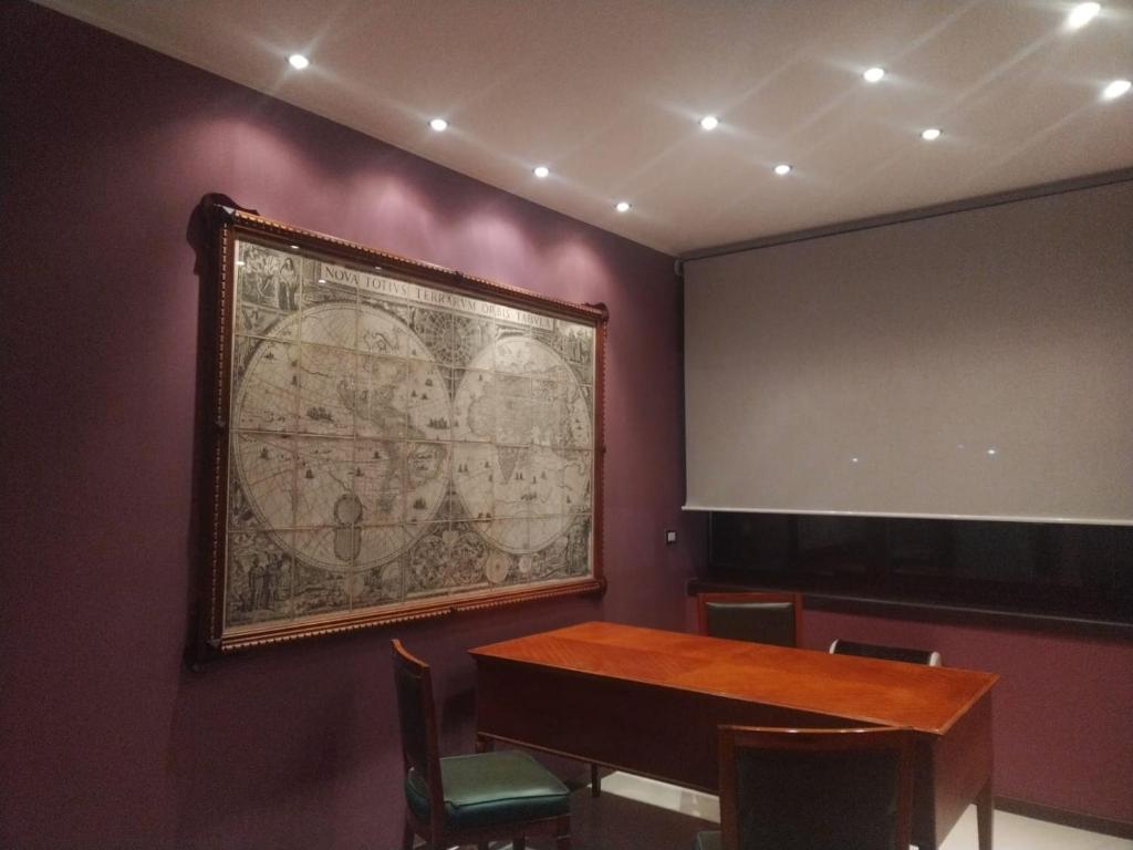 a meeting room with a large map on the wall at TWIN HOUSE brown in Tito
