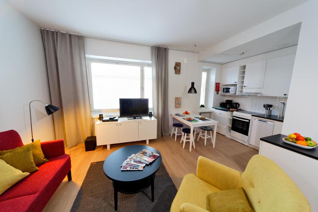 a living room with a couch and a table at Forenom Serviced Apartments Helsinki Kruununhaka in Helsinki