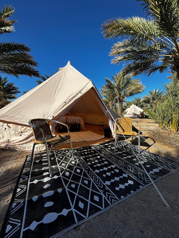 two chairs and a tent with palm trees at High Tanks Hideaway in Wellton
