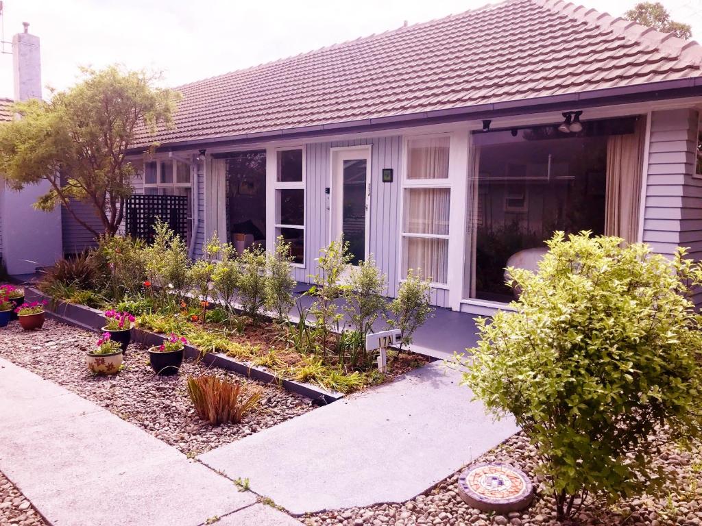 a house with a garden in front of it at Peaceful Pukerua Bay in Pukerua Bay