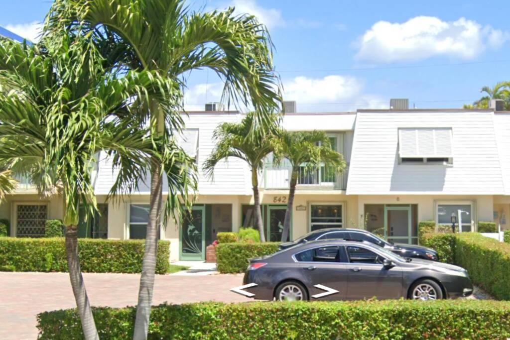a car parked in front of a house with palm trees at Deerfield Beach - Paradise in Deerfield Beach