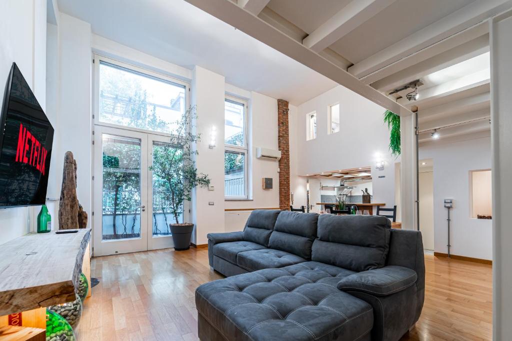 a living room with a couch and a table at LuxAvocadoLoft DUOMO 10m in Milan