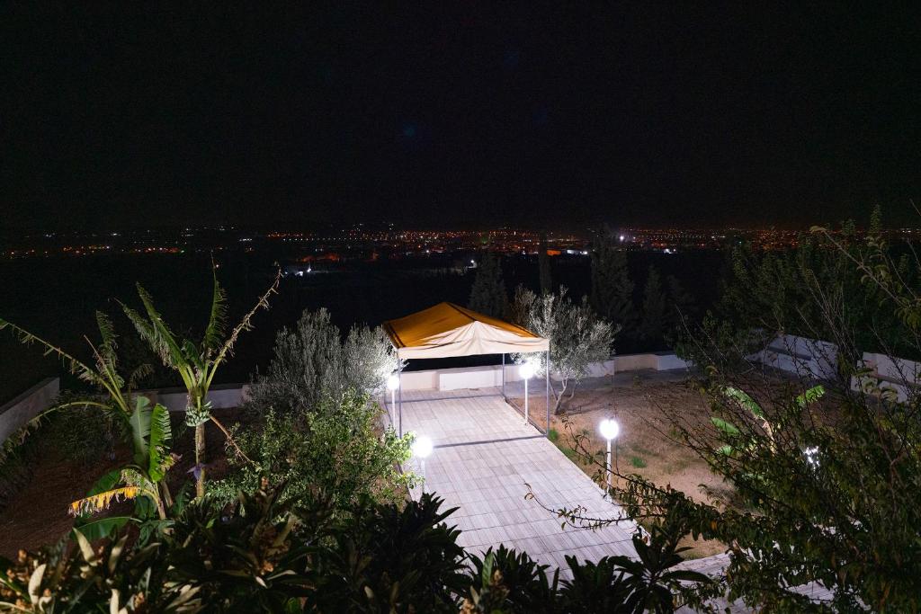 a tent at night with a city in the background at Cozy Home Stay 