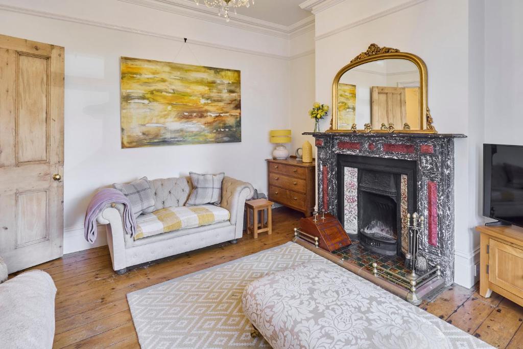 a living room with a fireplace and a couch at Host & Stay - Bellevue Road in Ramsgate