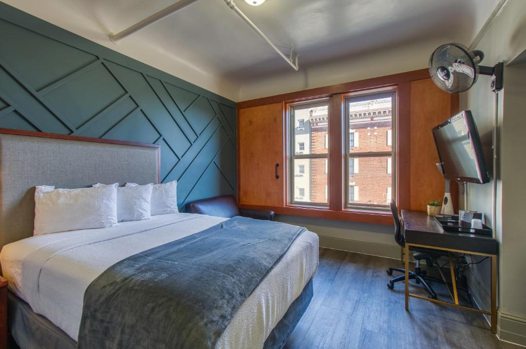 Ram's Hotel في سان فرانسيسكو: غرفة نوم فيها سرير وتلفزيون