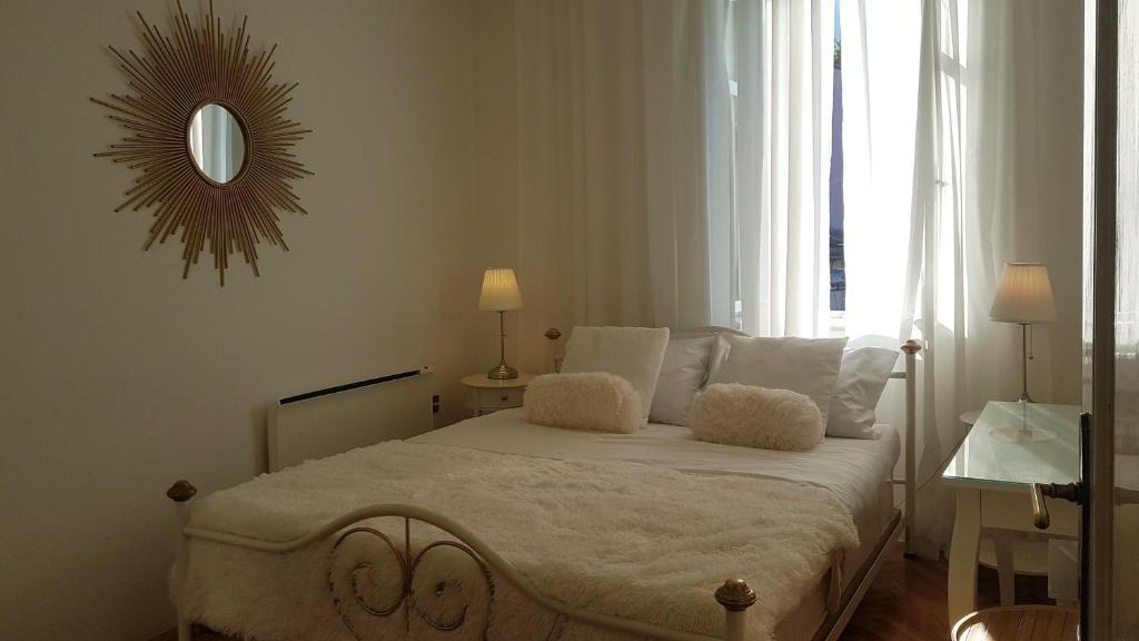a bedroom with a bed with a mirror on the wall at Apartments by the sea Lovran, Opatija - 14180 in Lovran
