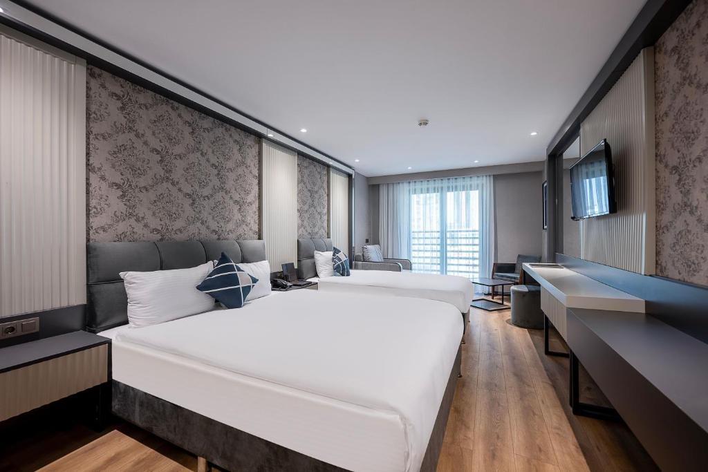 Postel nebo postele na pokoji v ubytování Four Points Flex by Sheraton Antalya Lara