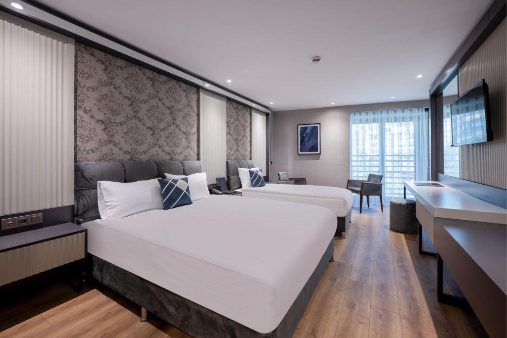 Postel nebo postele na pokoji v ubytování Four Points Flex by Sheraton Antalya Lara