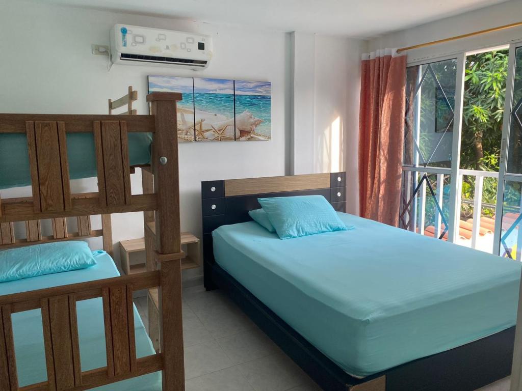 a bedroom with two bunk beds and a balcony at Hostel ISABELLA in Santa Marta