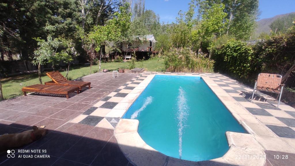 a swimming pool in a yard with a patio at aires de montaña in Ciudad Lujan de Cuyo