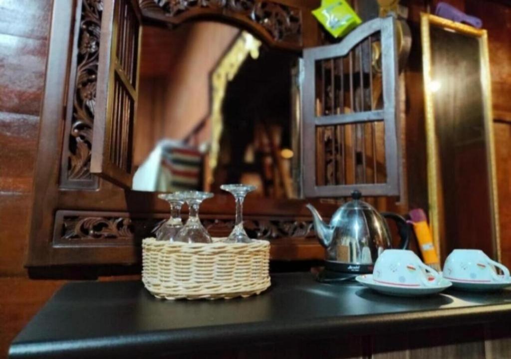 a counter top with a basket and glasses on it at Bujak Permai Villa Matahari Lombok NTB in Praya