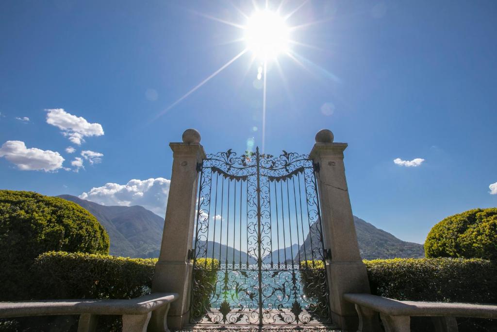 a gate with the sun shining behind it at Love of Lugano - Happy Rentals in Lugano
