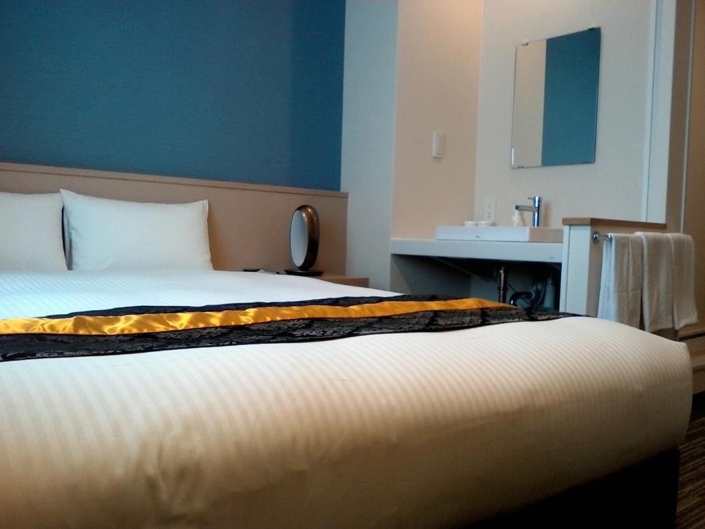 Postel nebo postele na pokoji v ubytování Bande Hotel Osaka