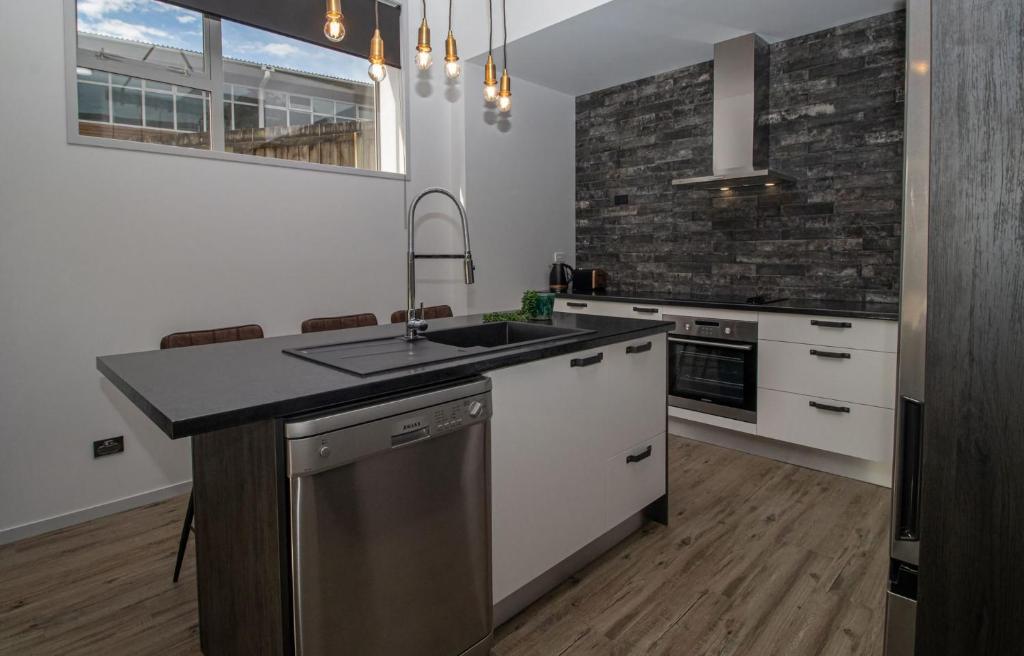 a kitchen with a sink and a counter top at City Living Apartment Three in New Plymouth