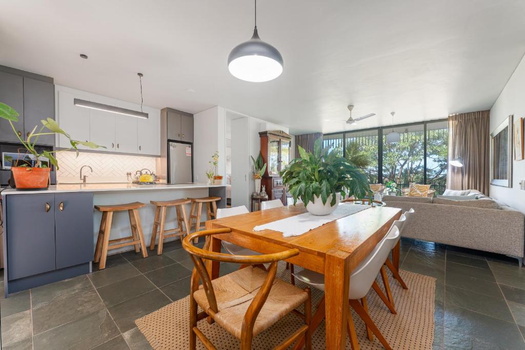 a kitchen and living room with a wooden table and chairs at 10 Dash Apartment, Dunkirk in Sheffield Beach