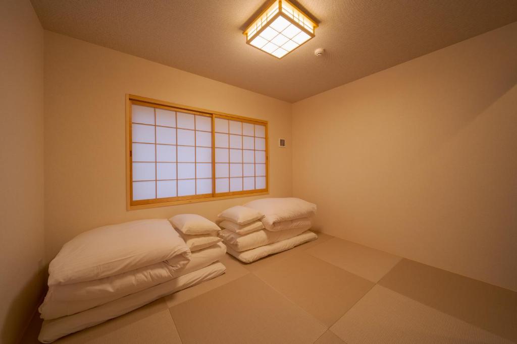 Postel nebo postele na pokoji v ubytování 旅の宿 花景色 Tabi no yado Hanageshiki