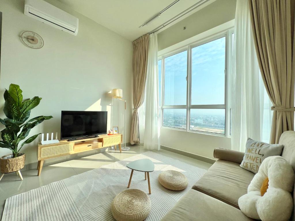 a living room with a couch and a large window at Melaka AmberCove 2R2B 5 pax 1 Parking Melaka Straits View Pool in Melaka