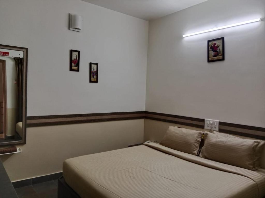 a bedroom with a bed in a room at Hotel Sapthagiri Nest in Coimbatore