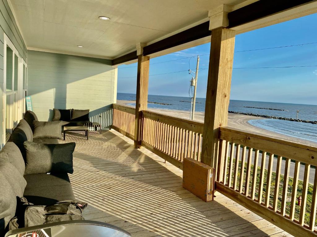 a screened in porch with a view of the beach at OceanFront home near HollyBeach in Cameron