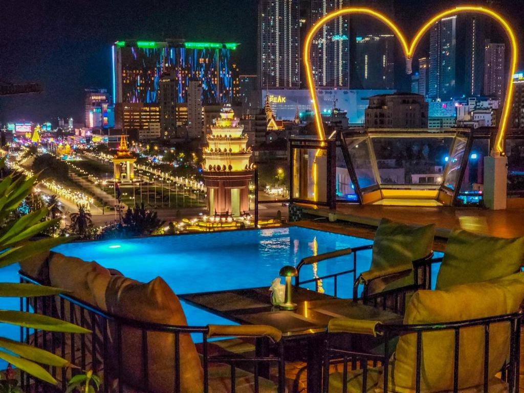 a bar with a view of the city at night at Phnom Penh 51 Hotel in Phnom Penh