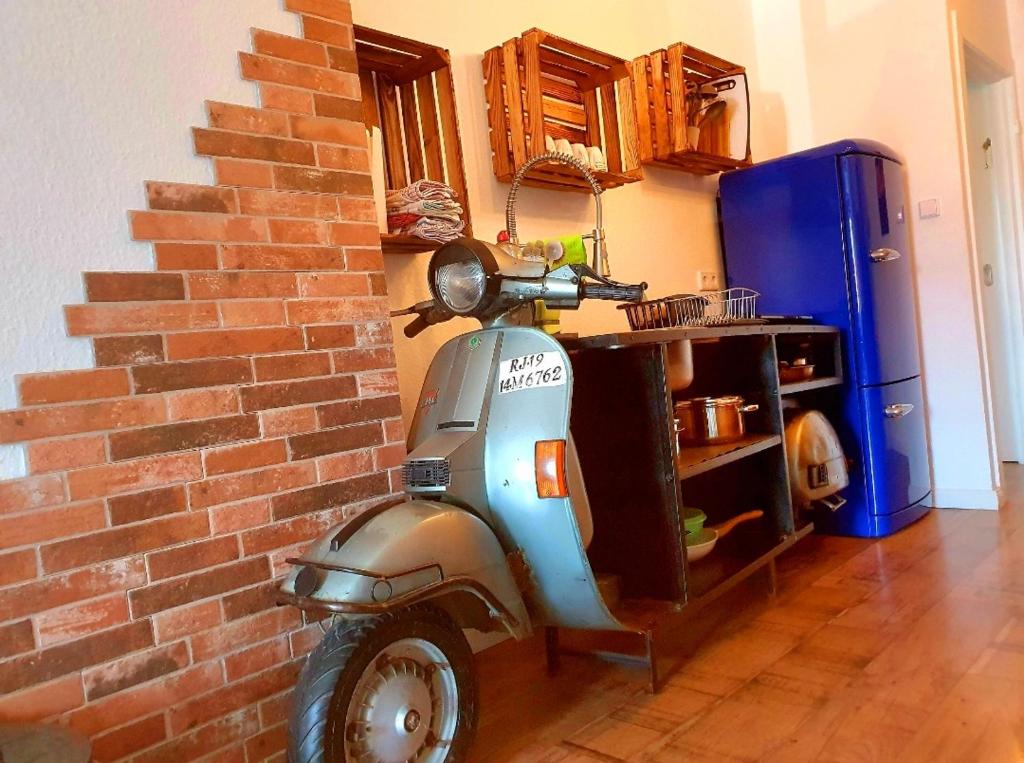 uma scooter estacionada ao lado de uma parede de tijolos em ***Ferienwohnung Hamburger Original*** em Halstenbek
